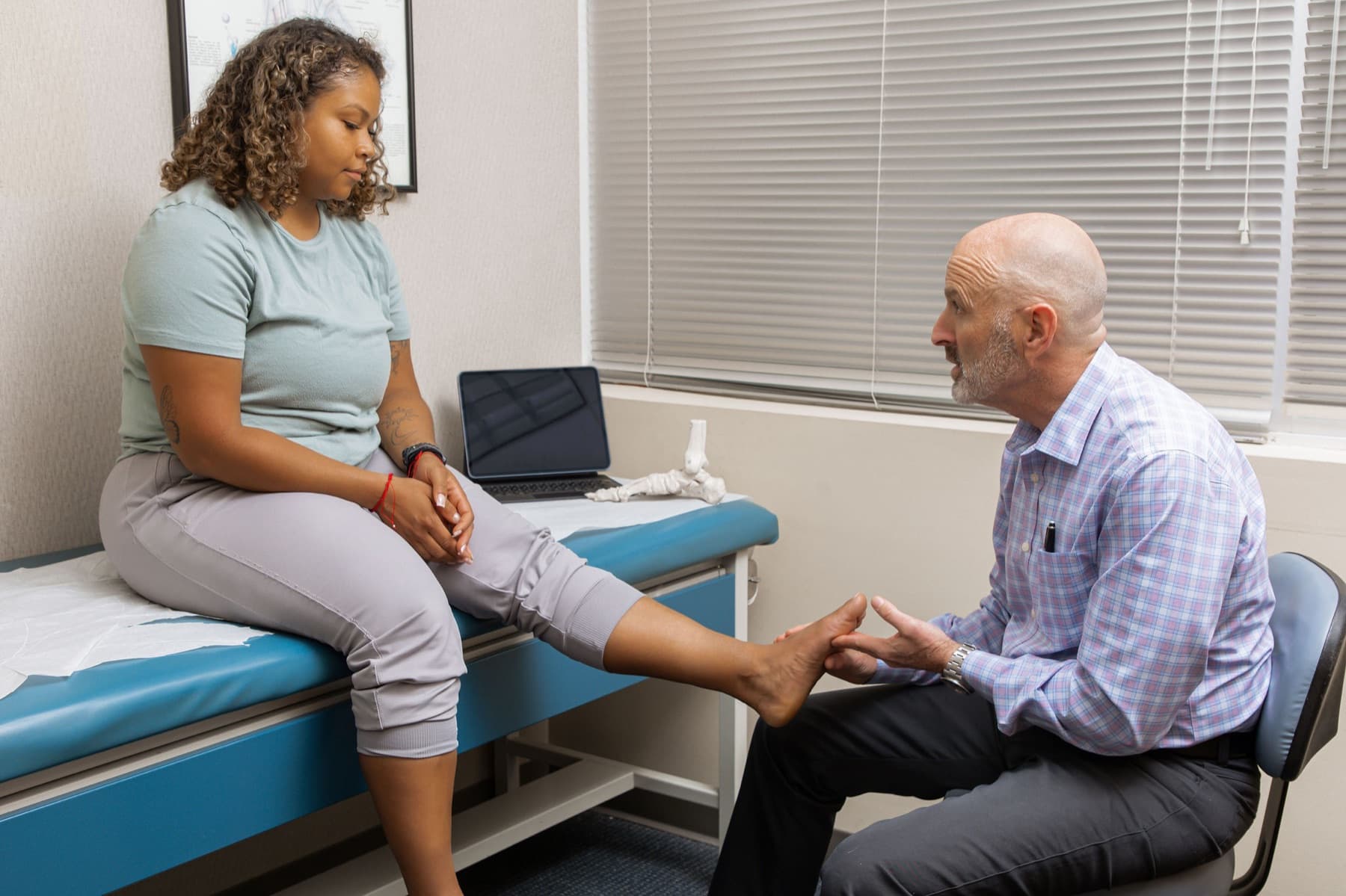 Dr. Feldman examining a patient’s foot during an appointment